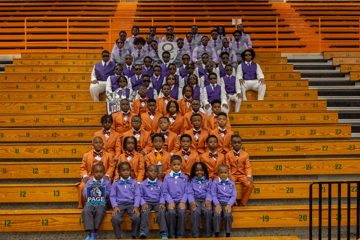 Lamplighter groups in coordinated formal attire seated together on gym bleachers.